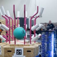 Robot putting balloon in contraption